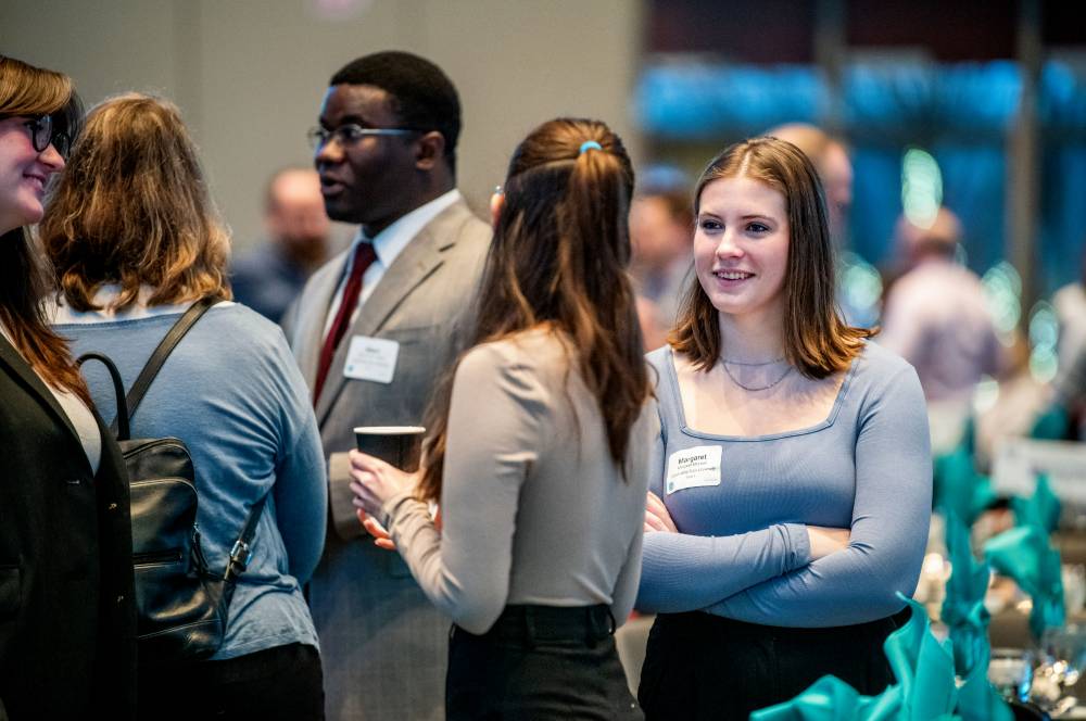 Students conversing at the West Michigan Economic Forecast